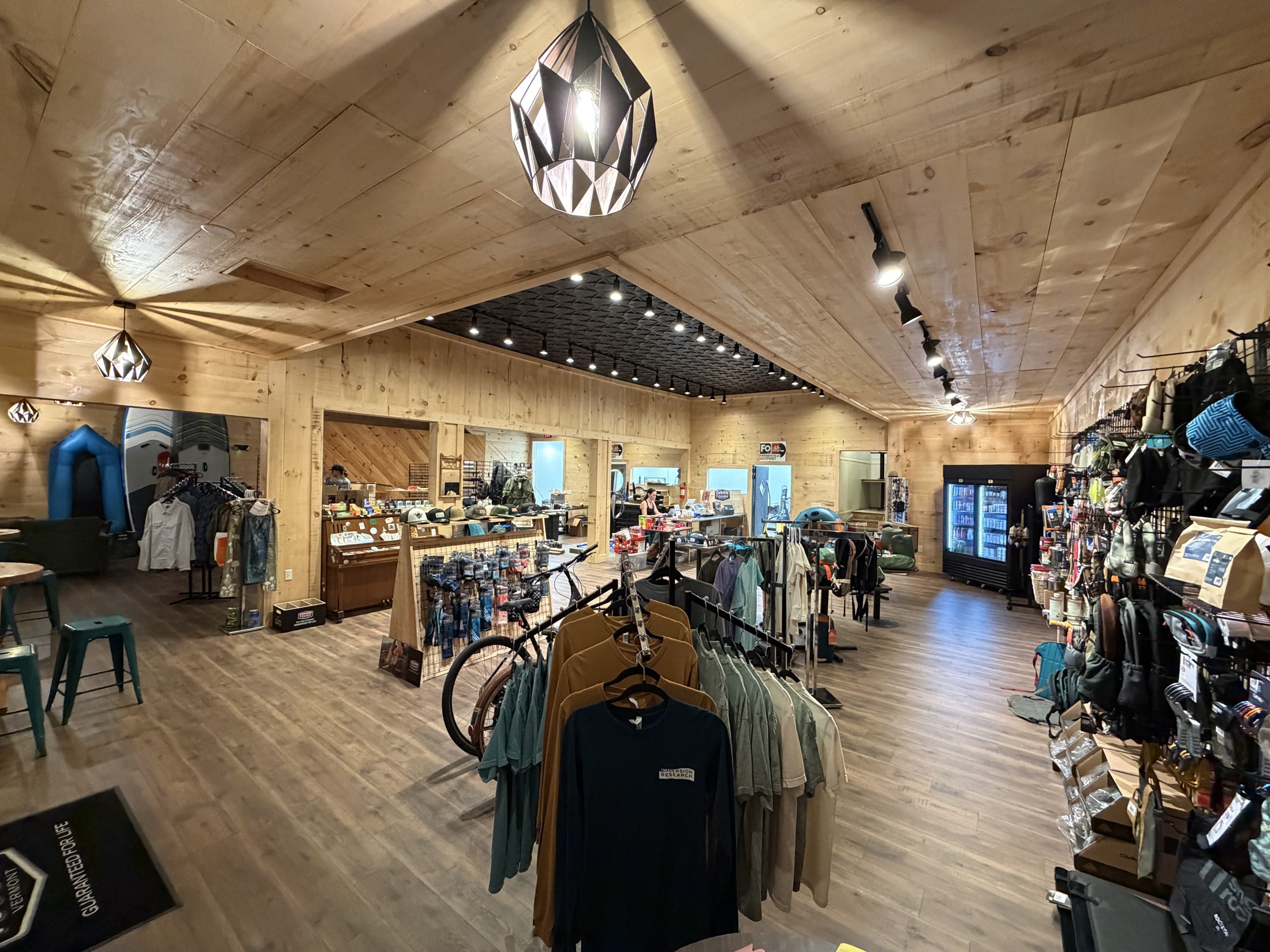 Inside Friendsville Outpost, with outdoor clothing, bikes, paddling gear, and supplies.